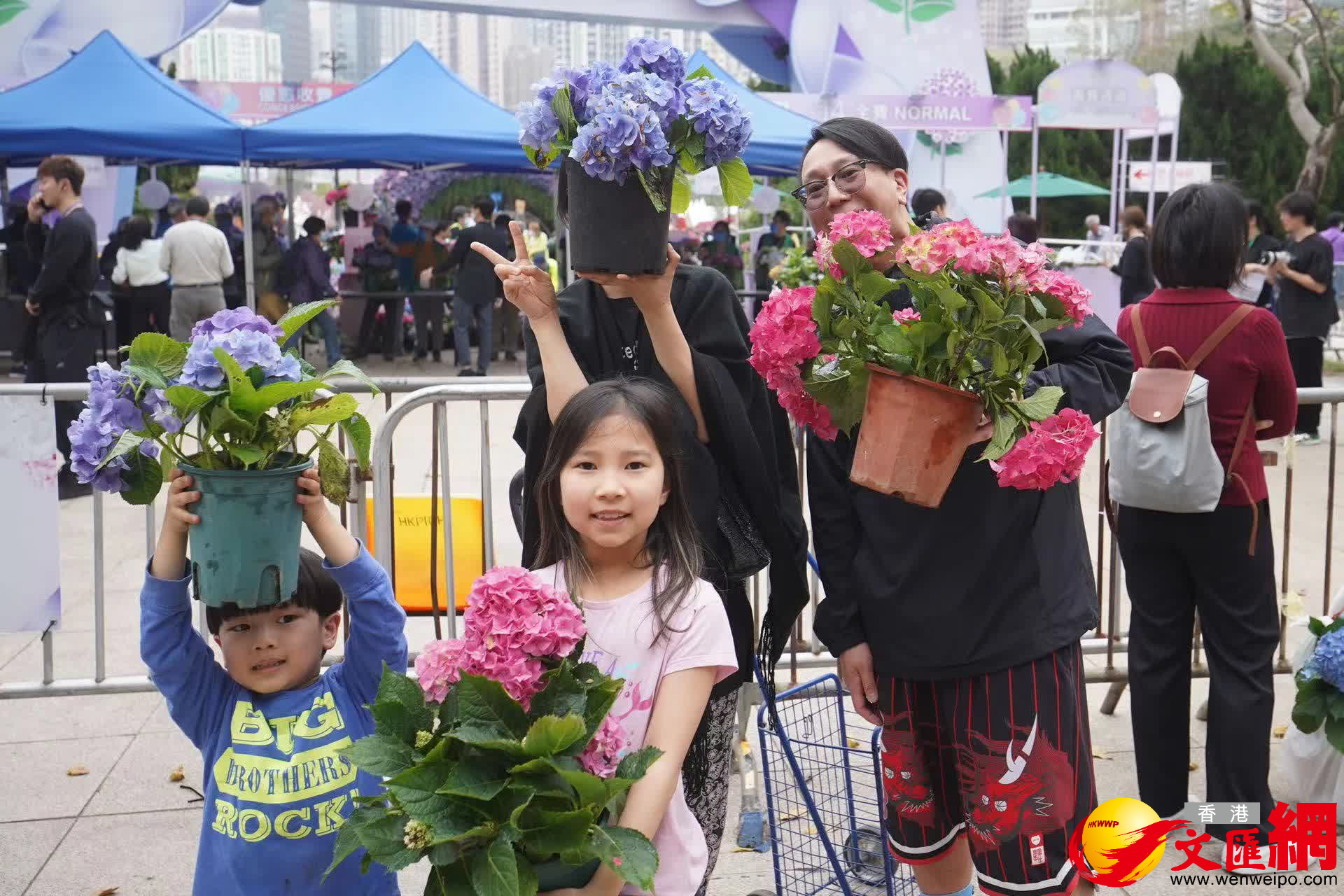 市民一家四口領得靚花,笑容滿面。(大公文匯全媒體記者麥鈞傑攝) 市民一家四口領得靚花,笑容滿面。(大公文匯全媒體記者麥鈞傑攝)