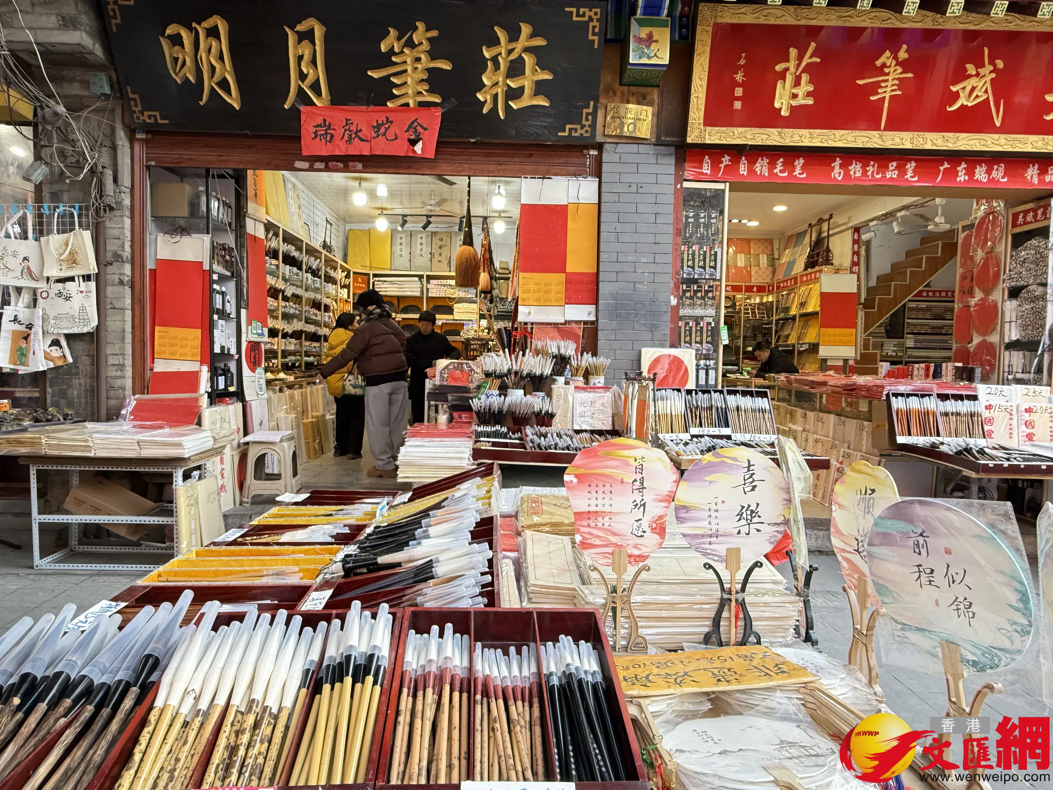 遊客在一家「貓狗畫像」店觀看店主創(chuàng)作。（記者張仕珍 攝）