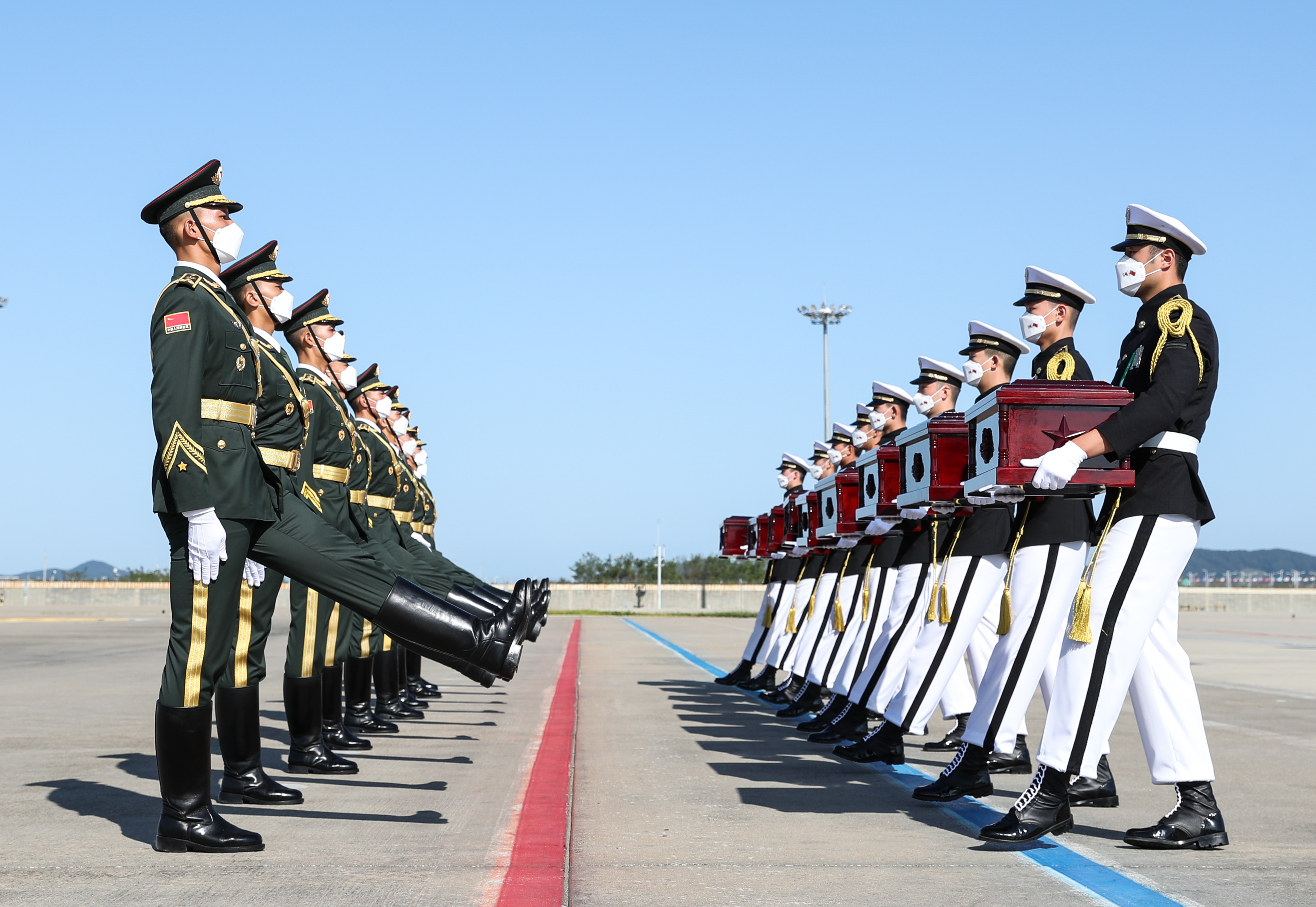 中韓雙方27日在韓國仁川國際機場舉行第七批在韓中國人民志願軍烈士遺骸交接儀式。圖為9月27日，在韓國仁川國際機場，韓方準備向中方禮兵（左）移交中國人民志願軍烈士遺骸。新華社