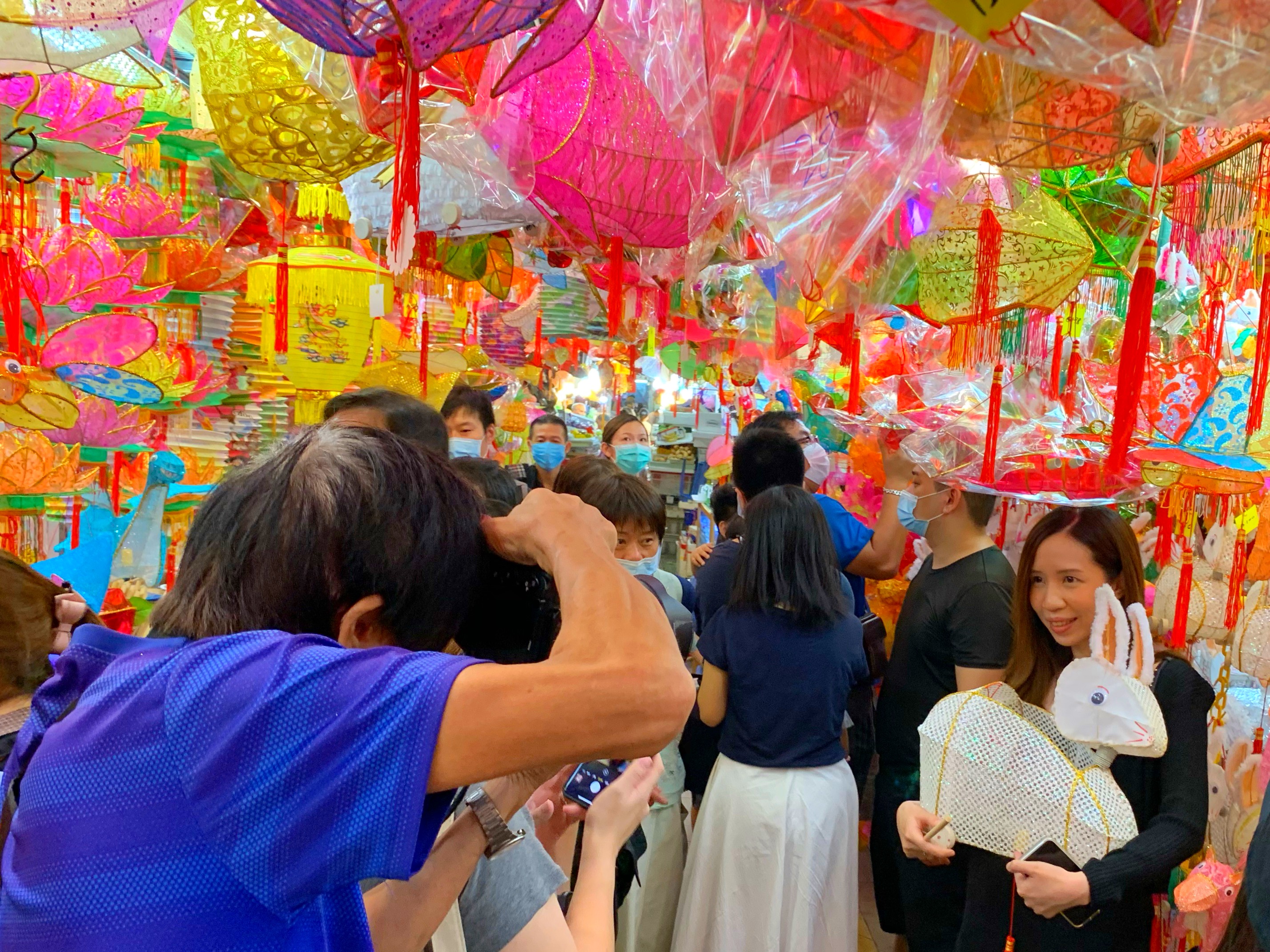 臨近中秋，元朗大橋街街市的「燈籠街」掛上各種造型、色彩繽紛的燈籠。隨着香港疫情漸趨緩和，很多市民到「燈籠街」打卡及選購心儀的傳統燈籠，感受節日氣氛。（大公文匯全媒體記者麥鈞傑 攝）