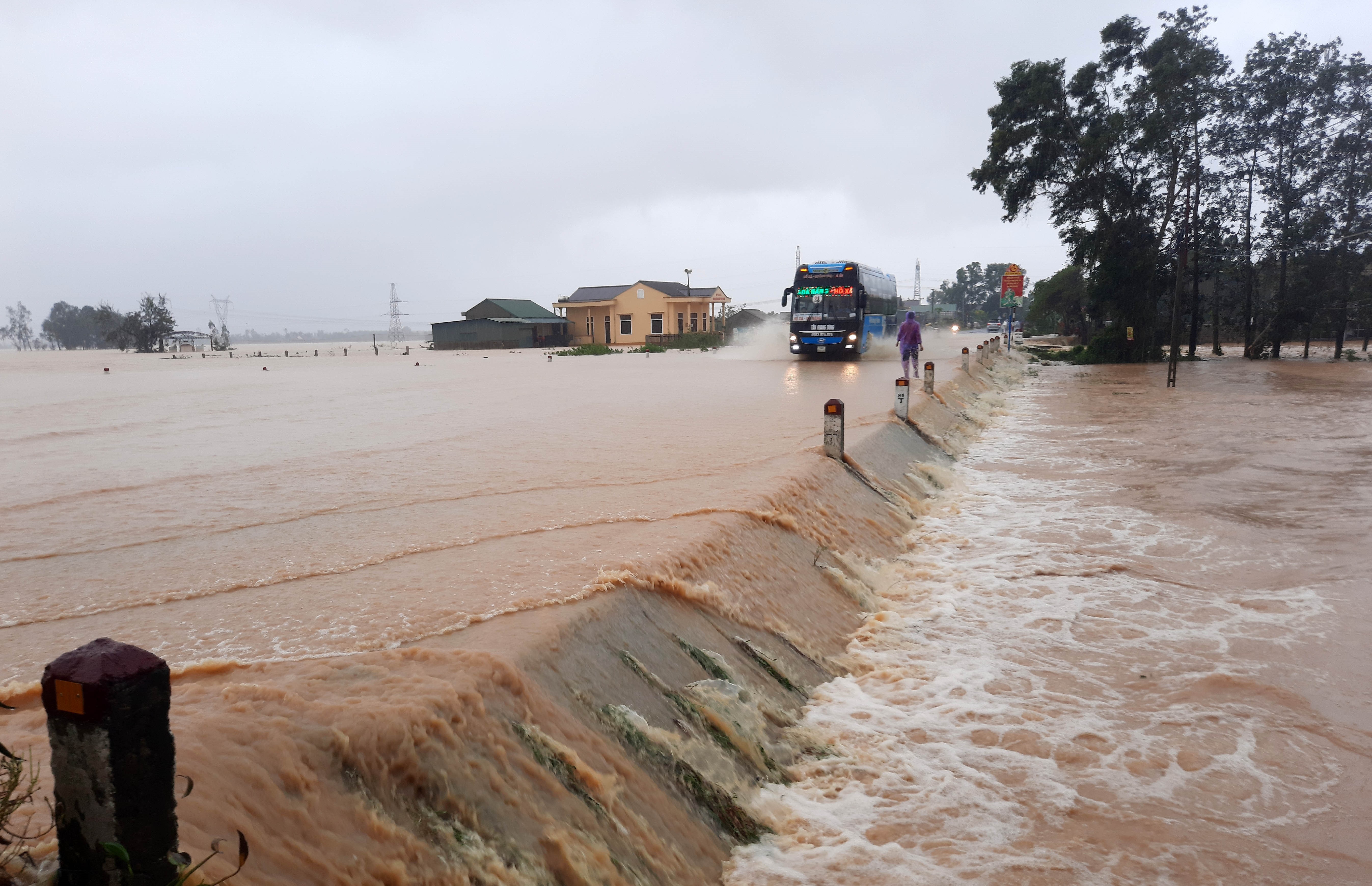 10月17日，在越南中部廣治省，車輛在被淹的公路上行駛。