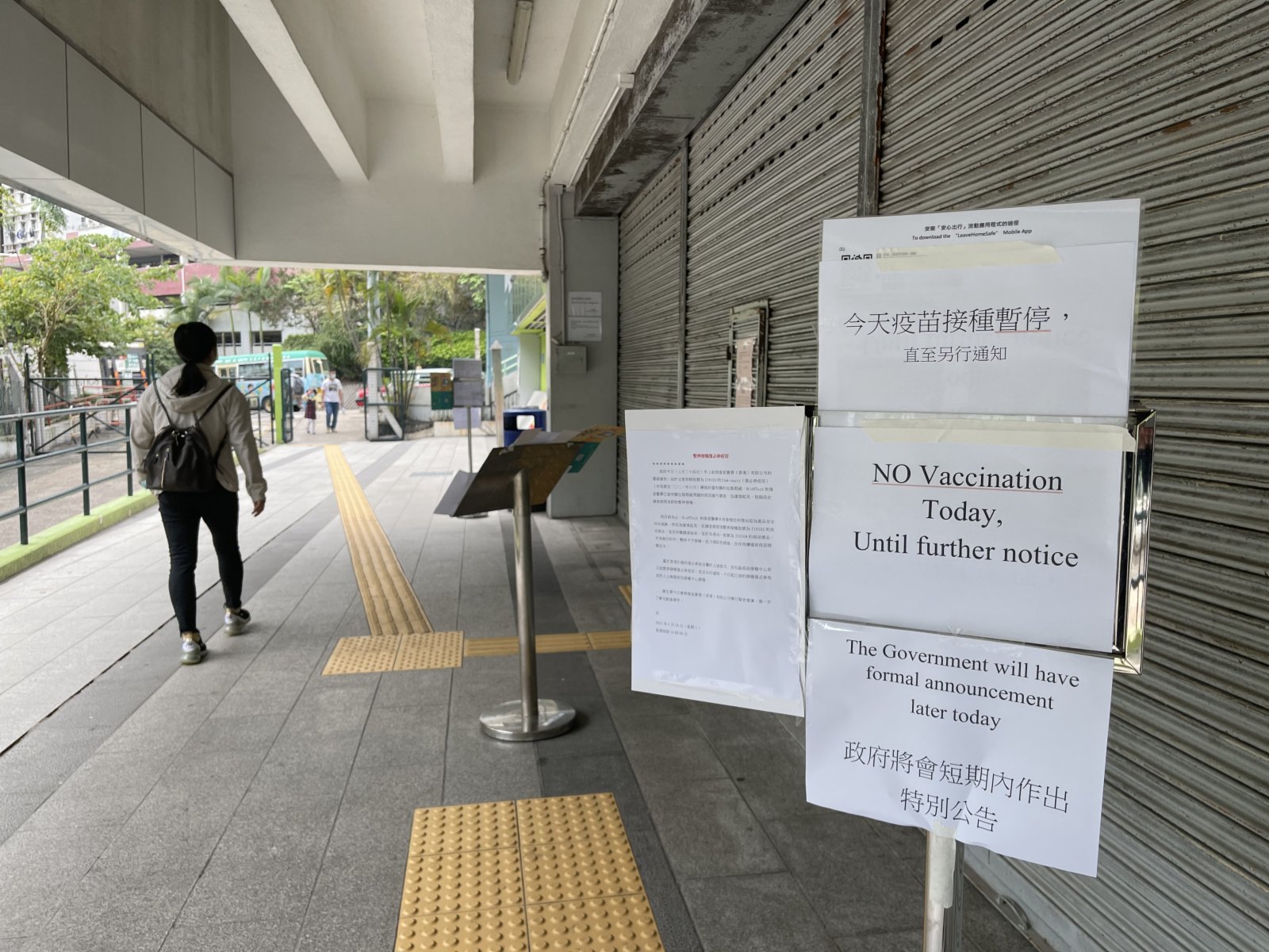 提供接種「復必泰」疫苗的觀塘曉光街體育館，張貼公告「今日疫苗接種暫停，直至另行通知」，接種中心大門關閉，只有少量工作人員進出場館。有部分路過的市民會駐足查看政府關於暫停「復必泰」疫苗新聞公報，並將信息告知家人，也有市民表示，希望政府盡快公布詳情，證明疫苗的安全性，否則會慎重考慮是否接種疫苗。（大公文匯全媒體記者攝）
