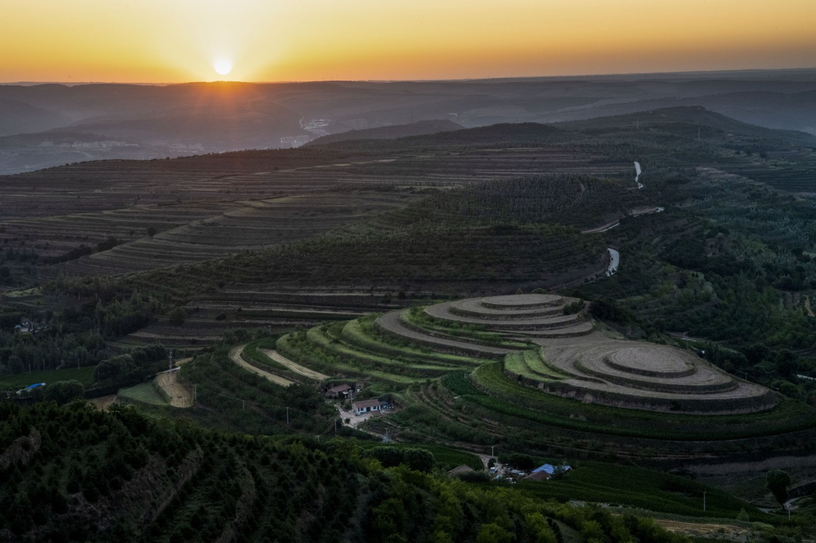 這是7月13日在寧夏固原市彭陽縣青雲灣旱作梯田公園拍攝的日出。（新華社）