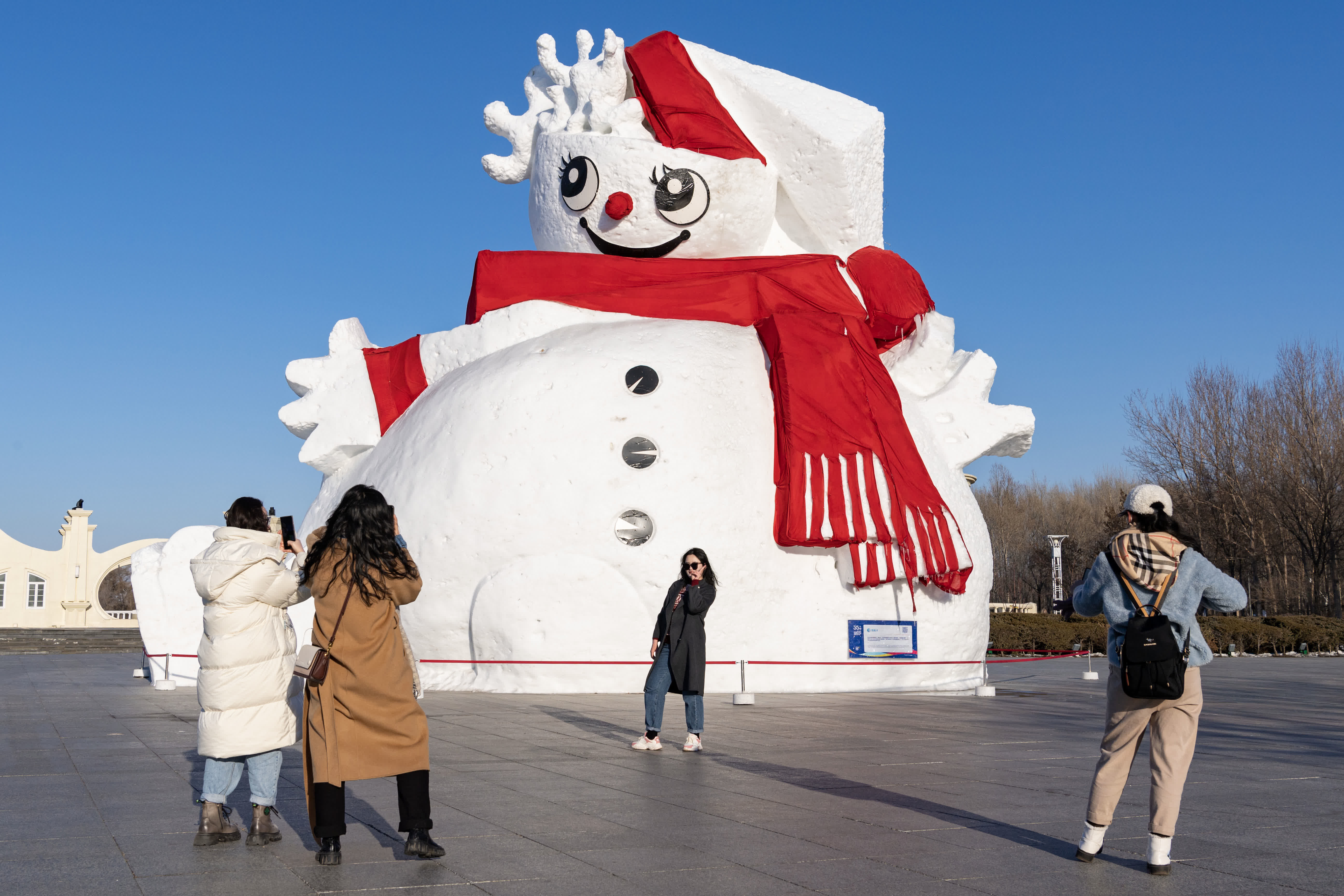 2月25日，遊客在哈爾濱太陽島雪博會入口的雪塑前拍照。