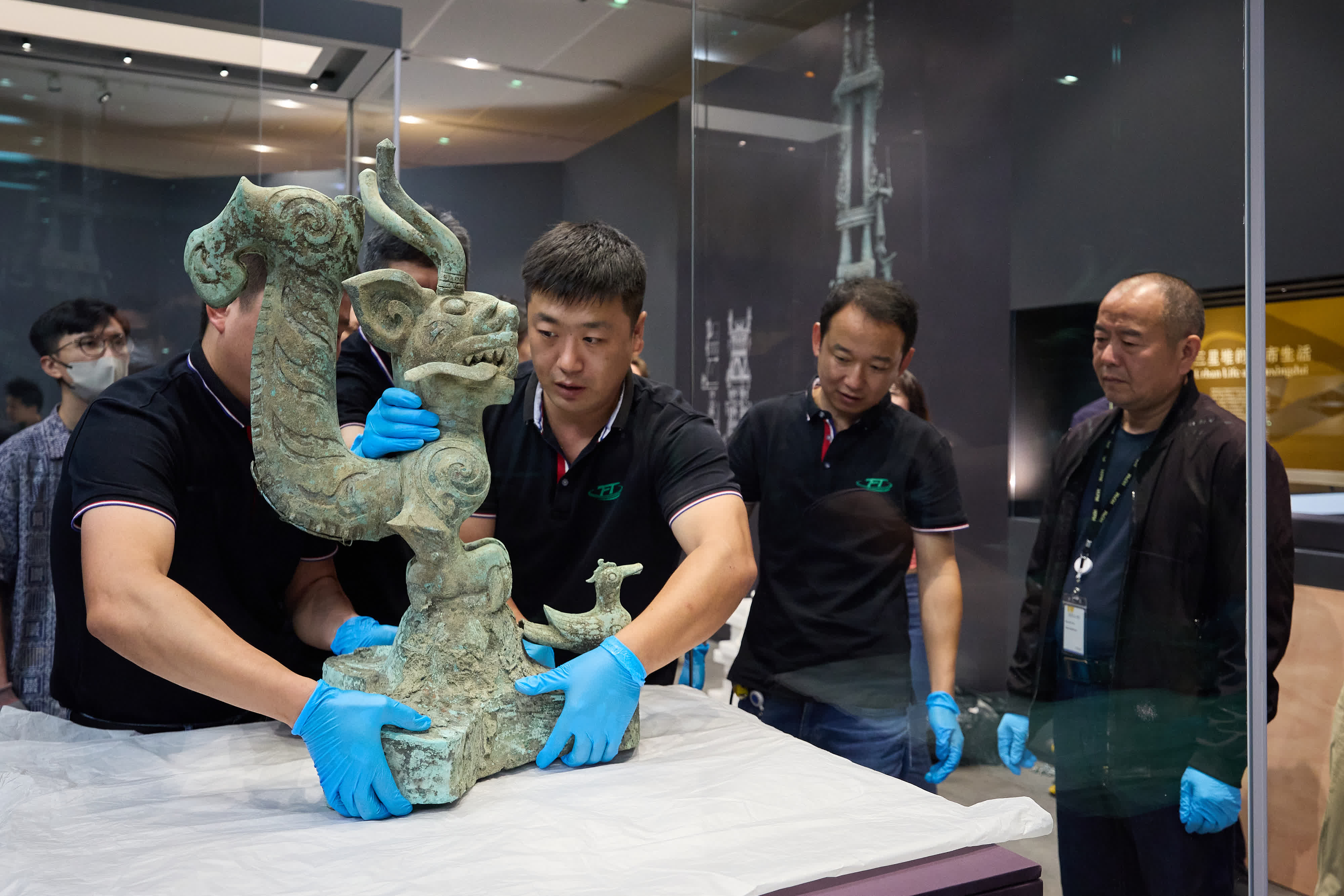 9月18日，布展團隊工作人員擺放文物「銅虎頭龍身像」。（香港故宮文化博物館）