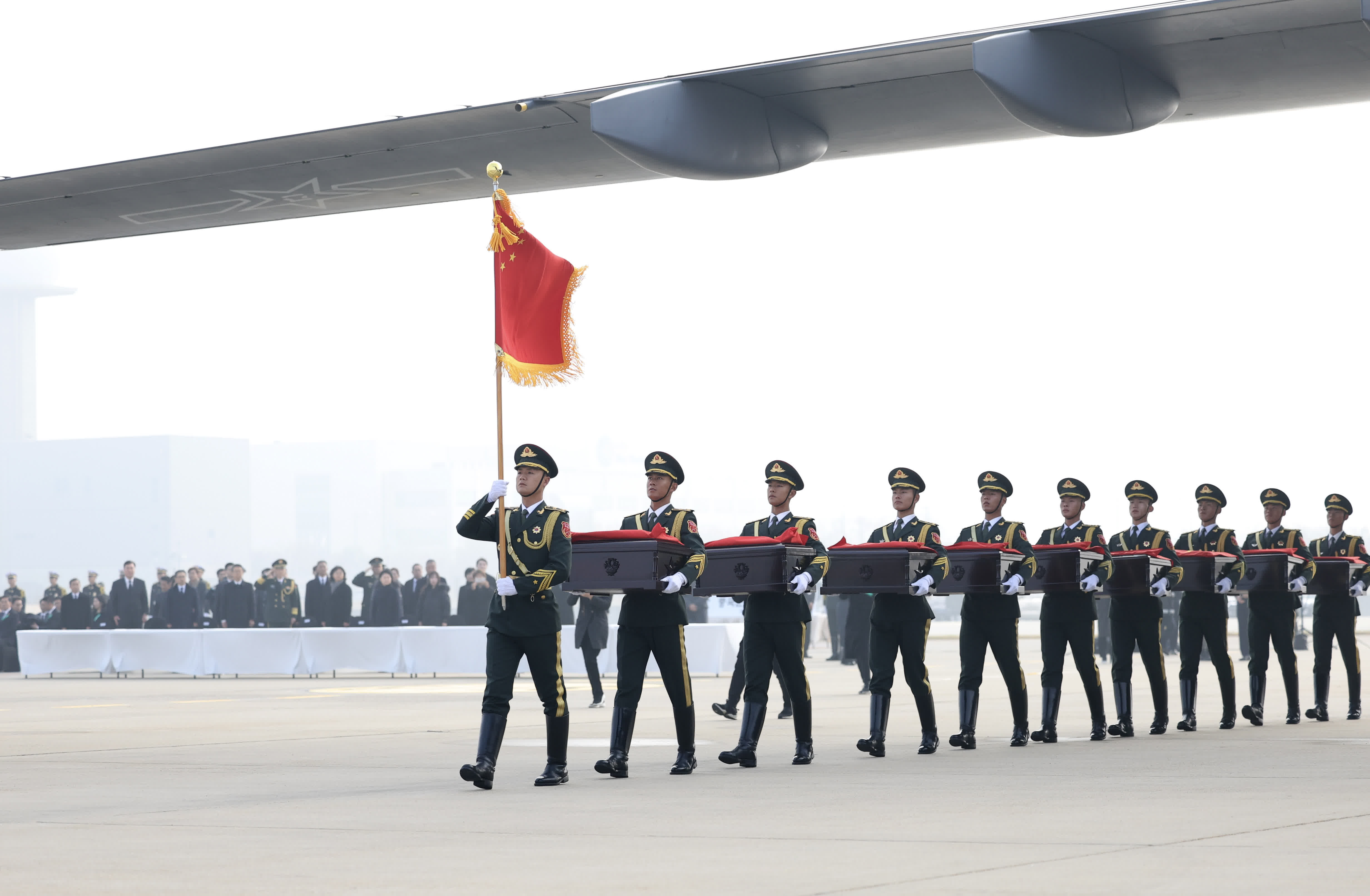 11月23日，在韓國仁川國際機場，中國人民解放軍禮兵準備護送烈士棺槨登上解放軍空軍專機。（新華社）