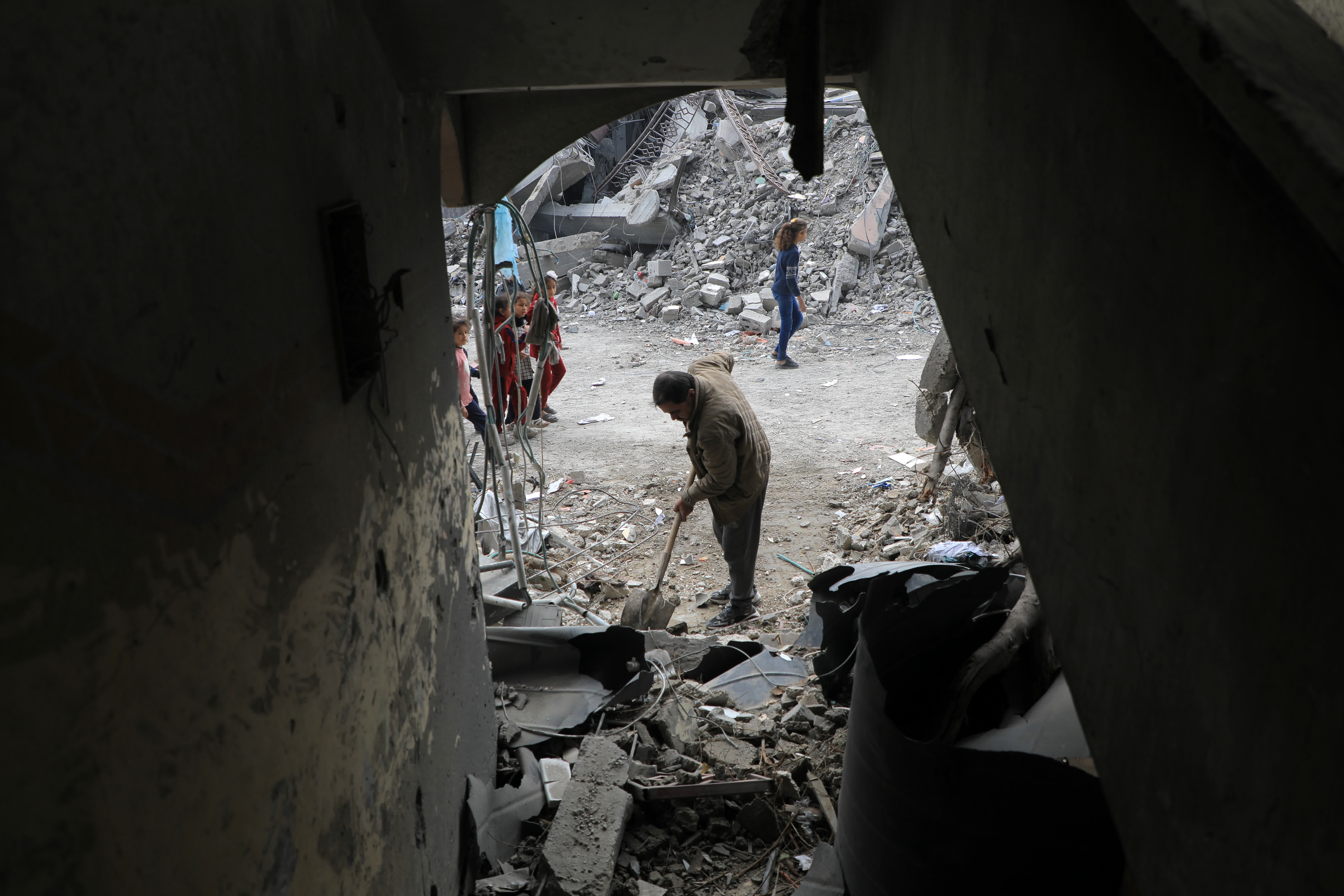 2月22日，一名男子清理加沙地帶南部城市拉法一處在以軍襲擊中損毀的建築。（新華社）
