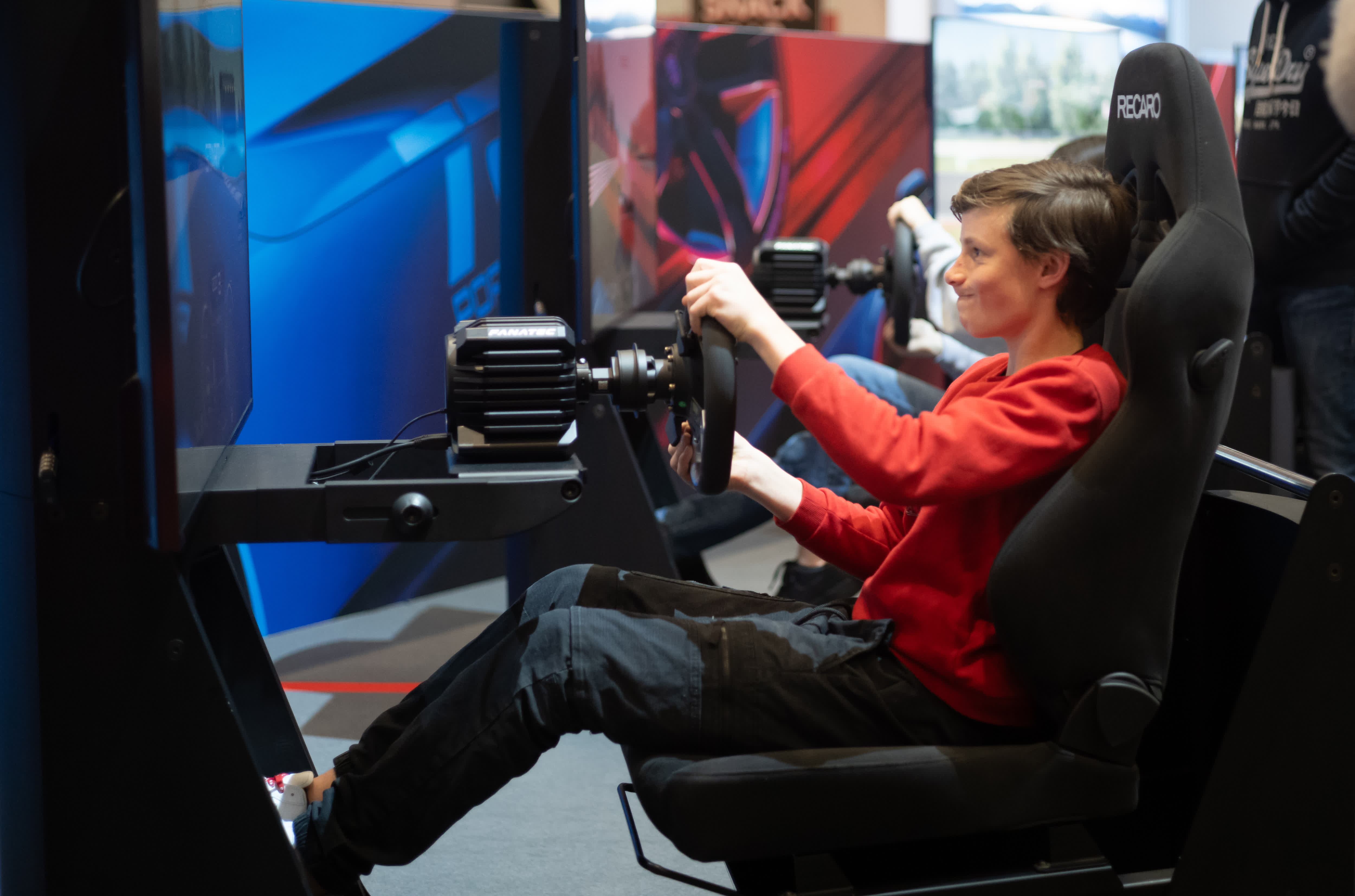 2月28日，一名觀眾在瑞士日內瓦舉行的2024年日內瓦國際車展上體驗模擬駕駛。（新華社）