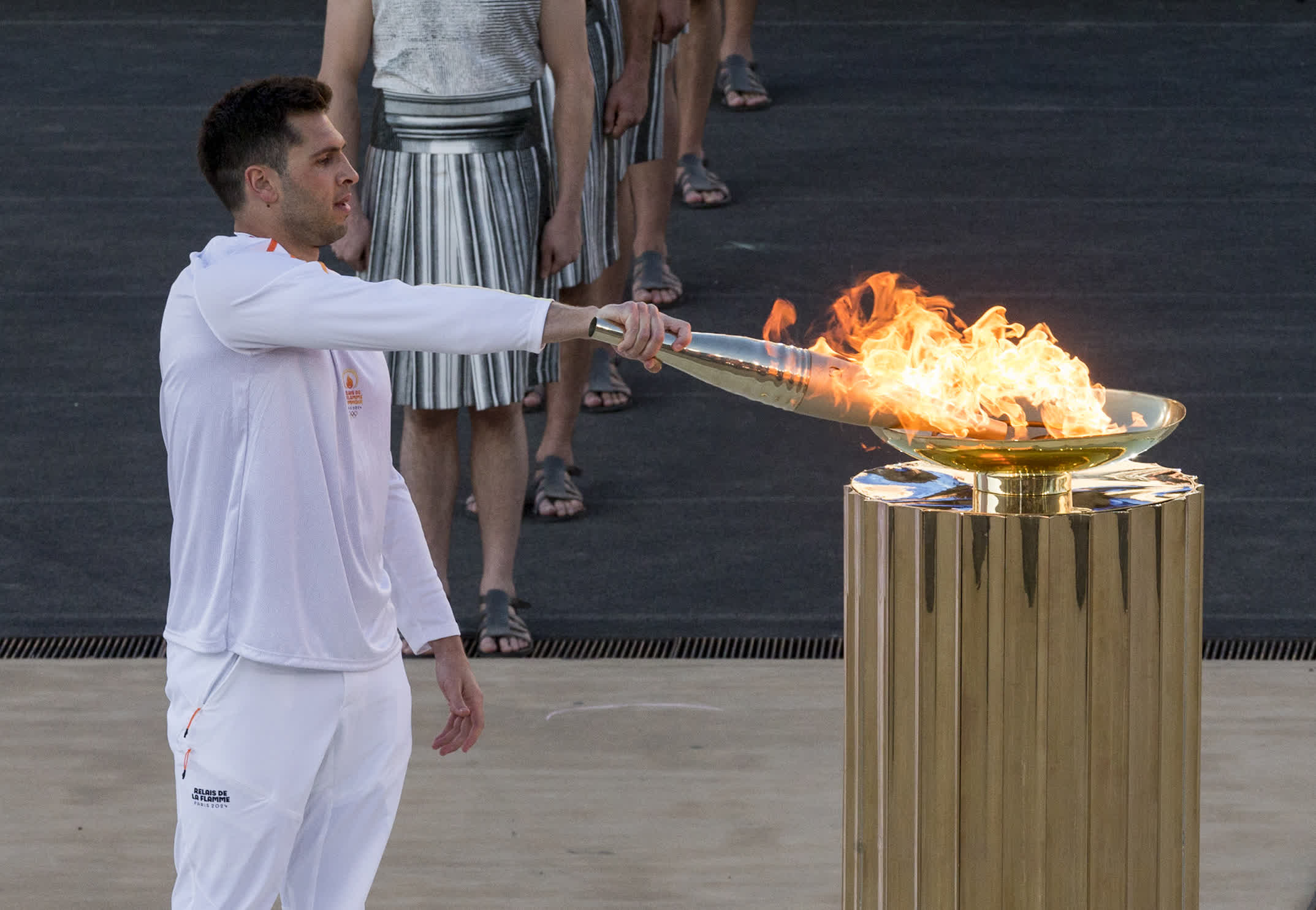  4月26日，最後一棒火炬手、希臘國家水球隊隊長馮圖利斯點燃聖火盆。（新華社）