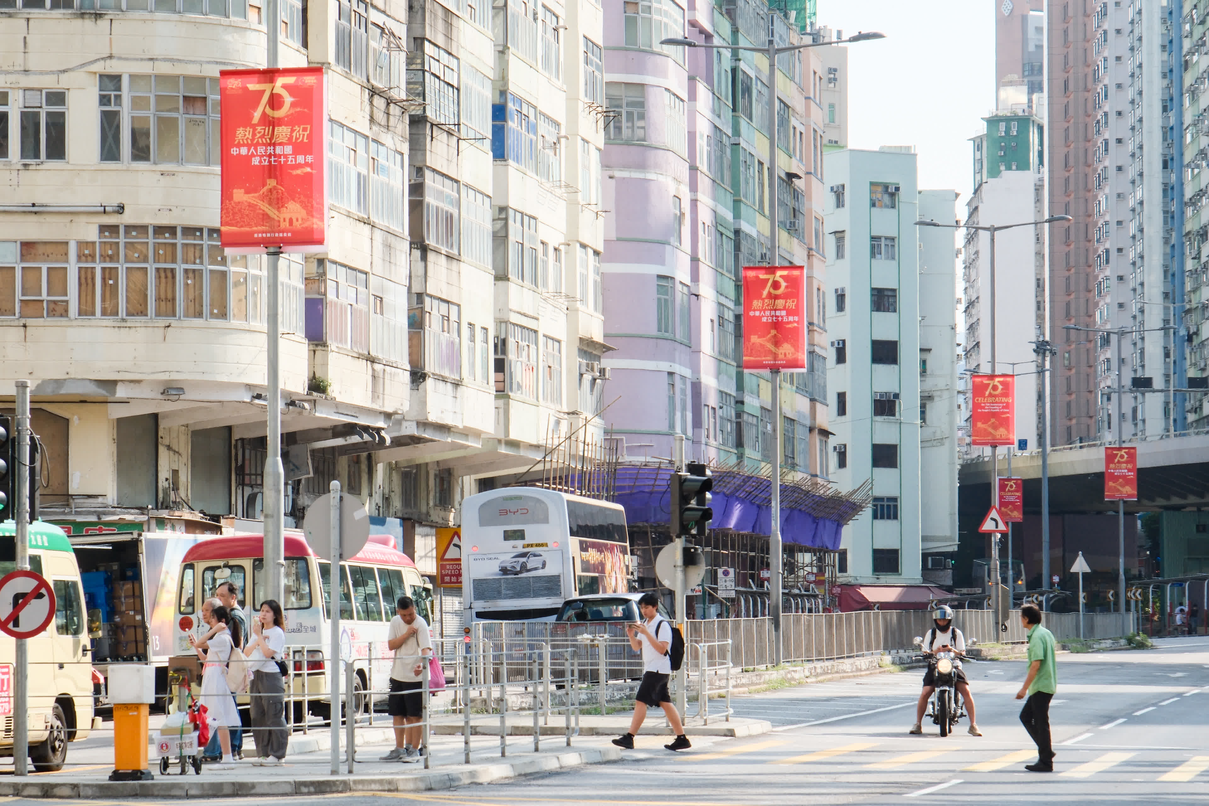 圖為九龍城區(qū)街頭的燈柱整齊掛滿慶國慶彩旗。（香港中通社）