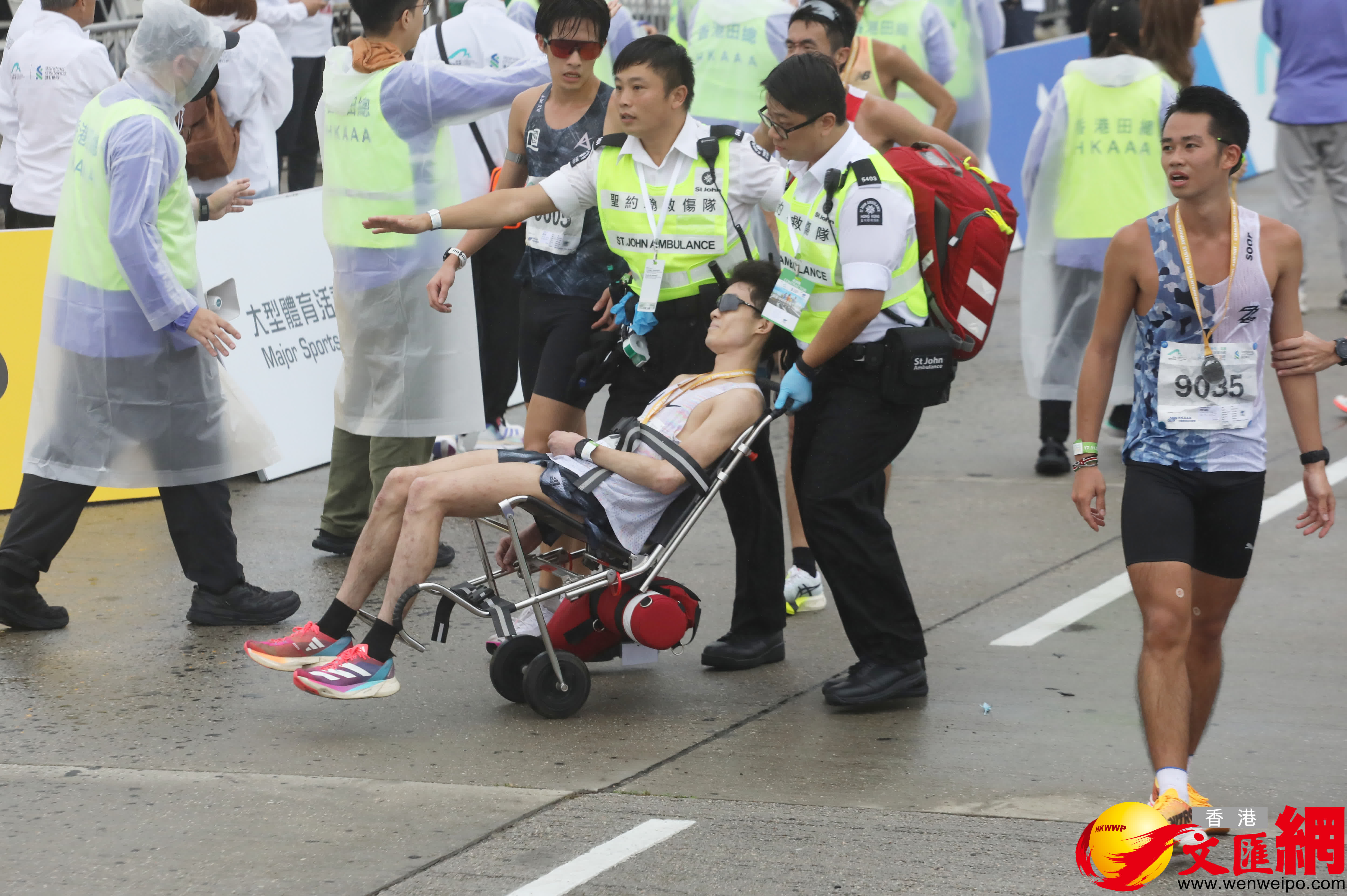 部分跑手不適倒地由擔架抬走。（香港文匯報記者郭木又攝）