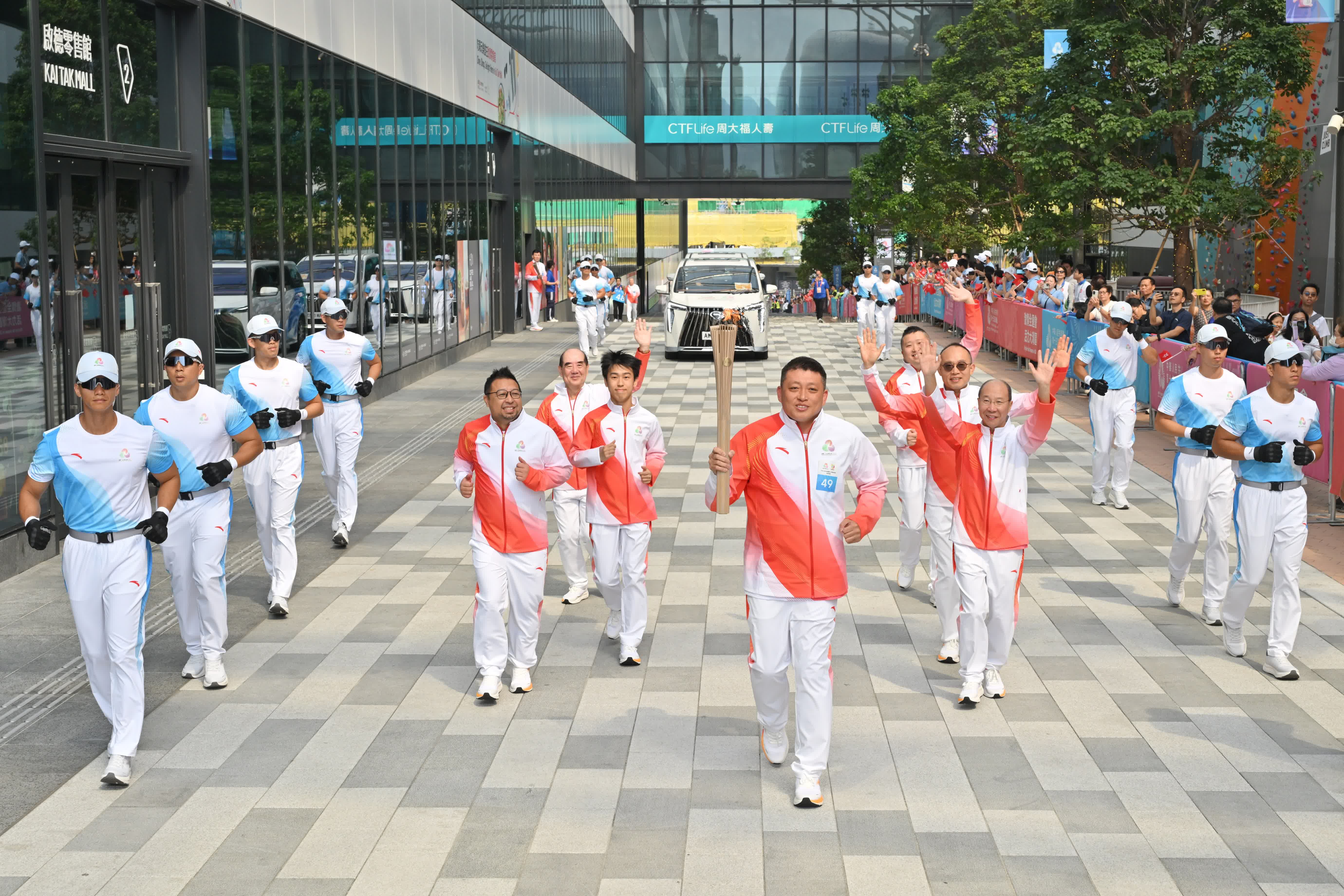 火炬手49號梁國成（第一排）與助跑火炬手何迪夫（第二排左）、黃江天（第二排右）、張樂行（第三排左）、周明（第三排右）、鍾德全（第四排左）和林浩峯（第四排右）。