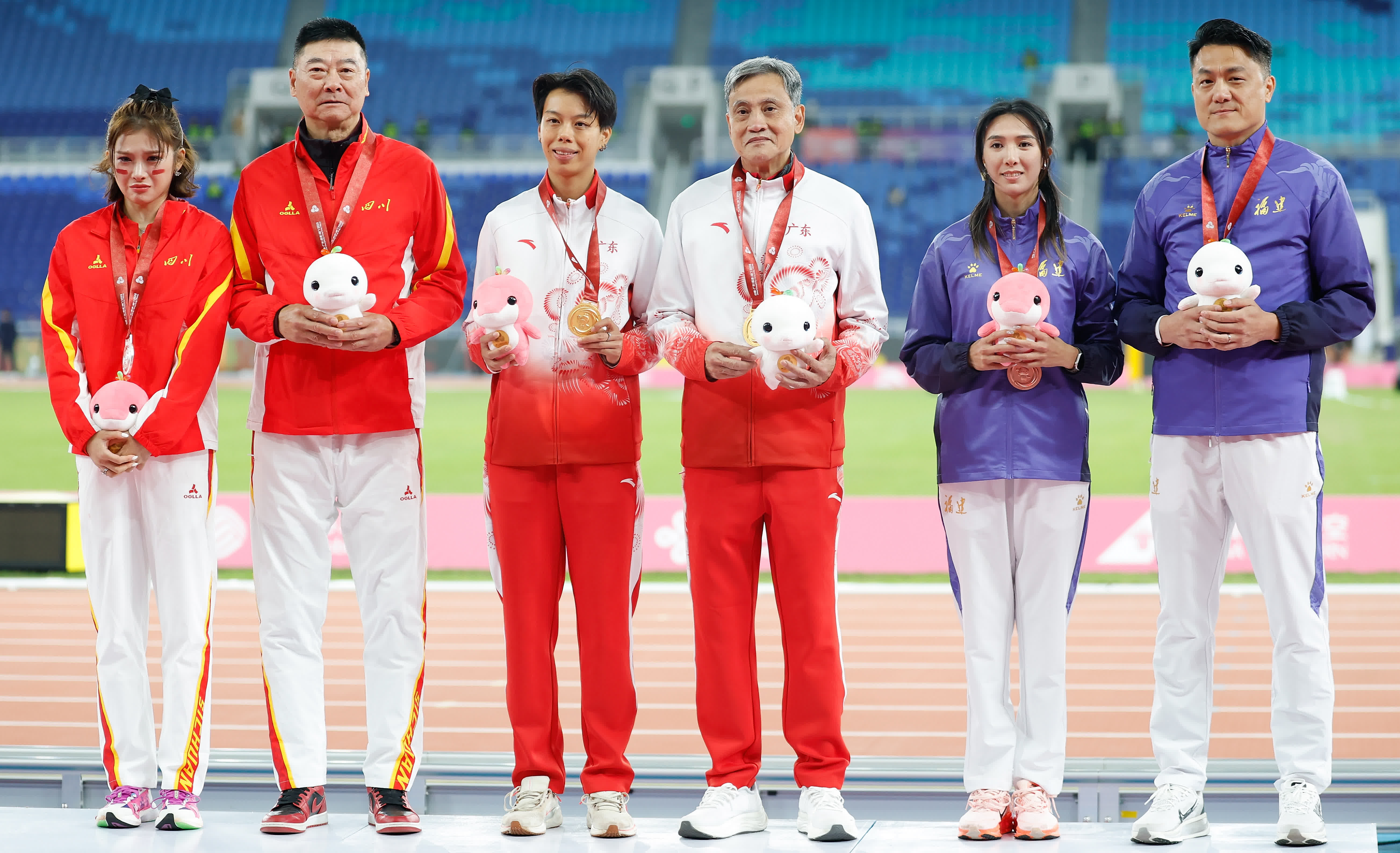 獲得冠軍的廣東隊選手劉景揚（左三）、獲得亞軍的四川隊選手吳豔妮（左一）、獲得季軍的福建隊選手林雨薇（右二）在頒獎儀式上與教練合影。新華社