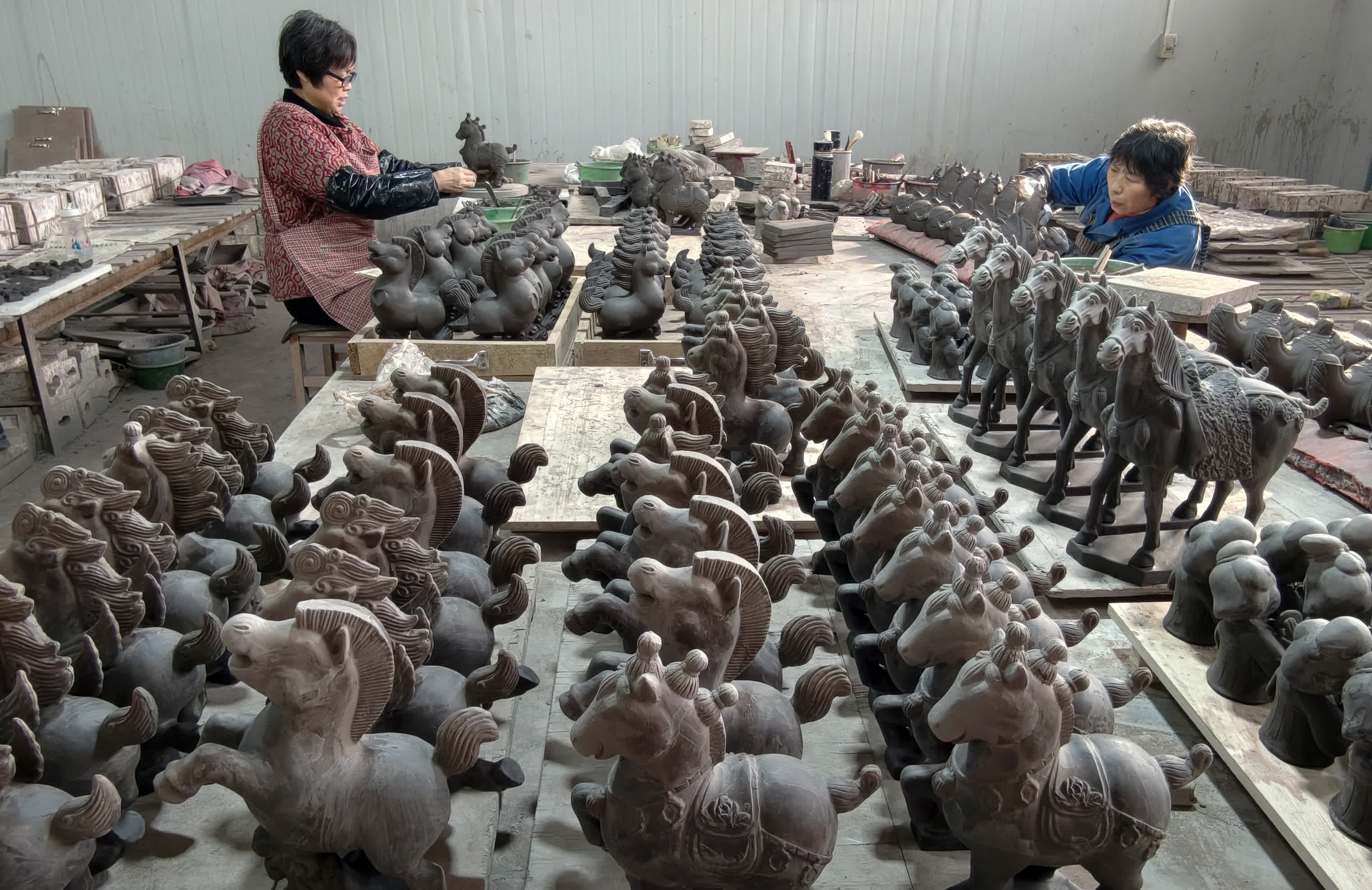 2月9日，村民在河南省洛陽市孟津區三彩小鎮製作唐三彩馬。（新華社）
