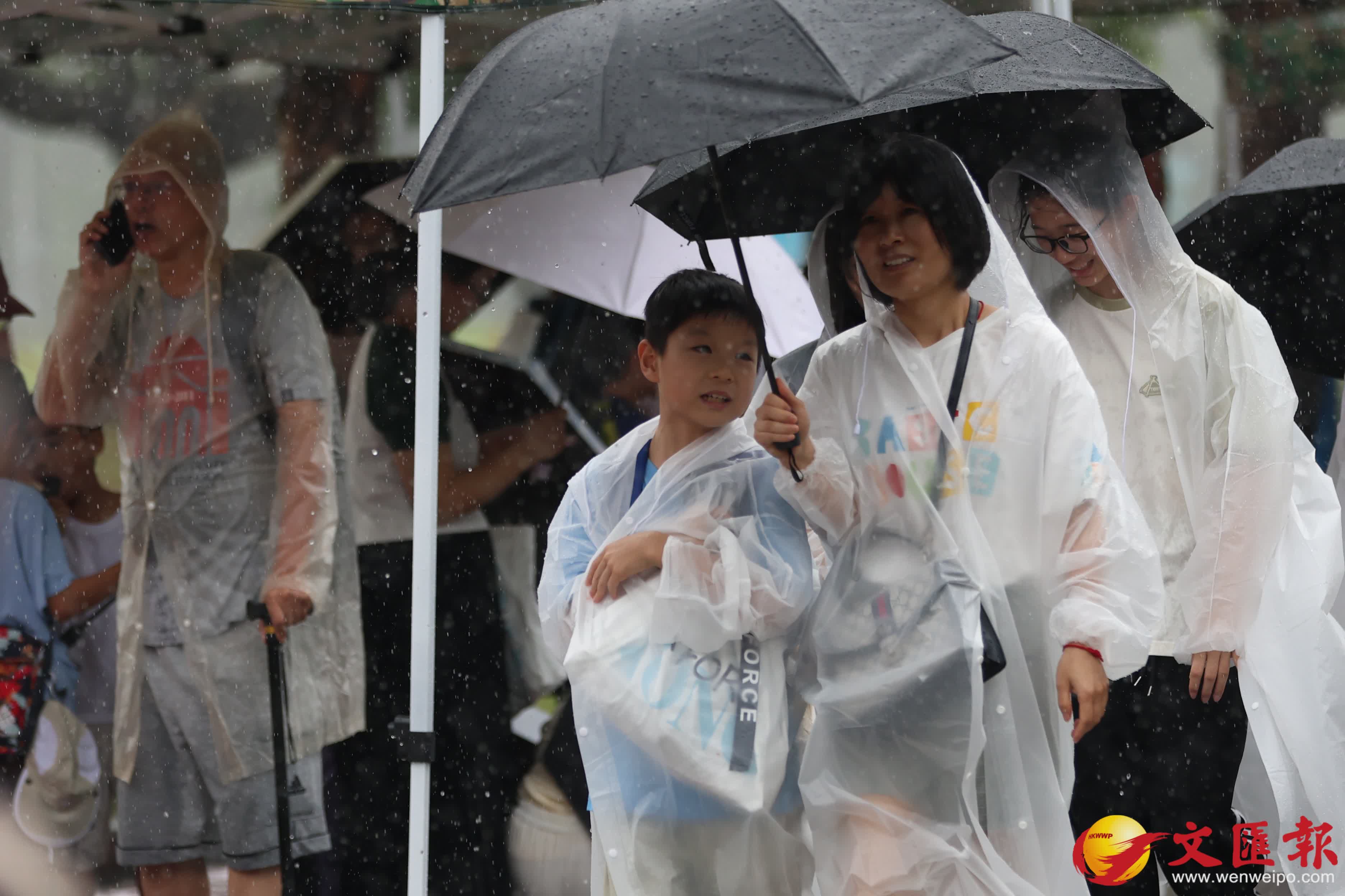 天文台發出黃色暴雨警告信號。市民在雨中前行。（香港文匯報記者萬霜靈攝）