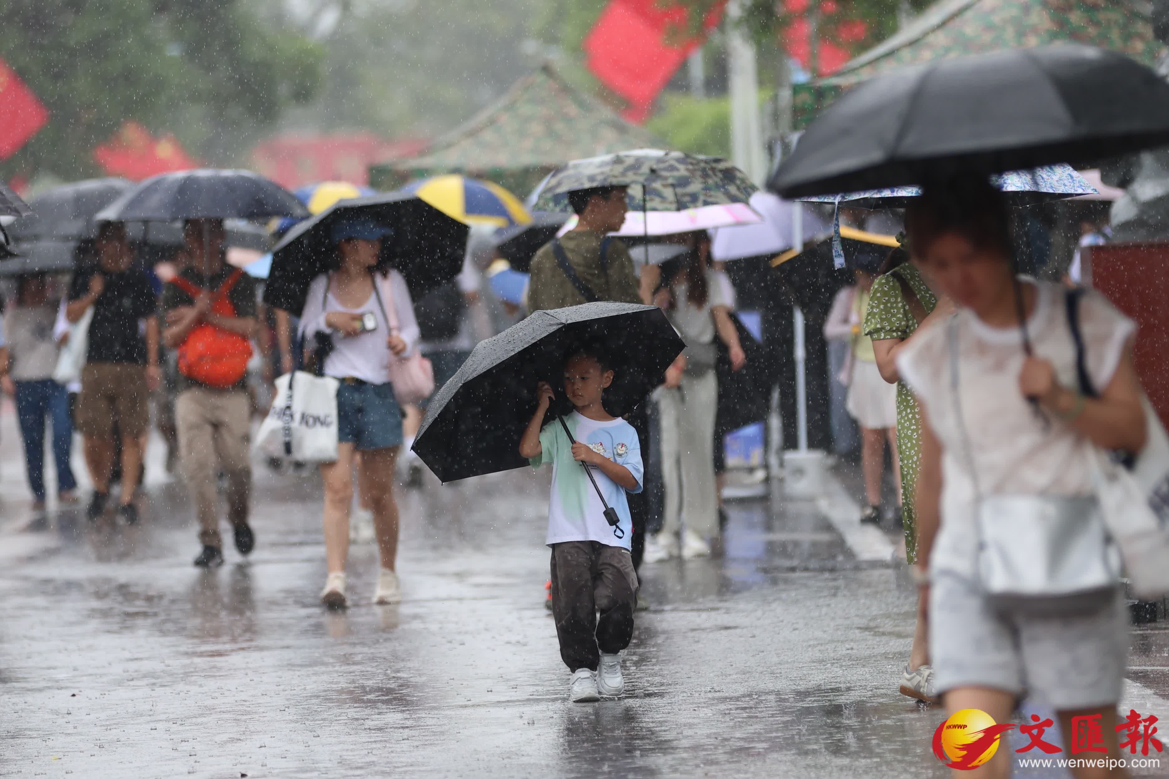 天文台發出黃色暴雨警告信號。市民在雨中前行。（香港文匯報記者萬霜靈攝）